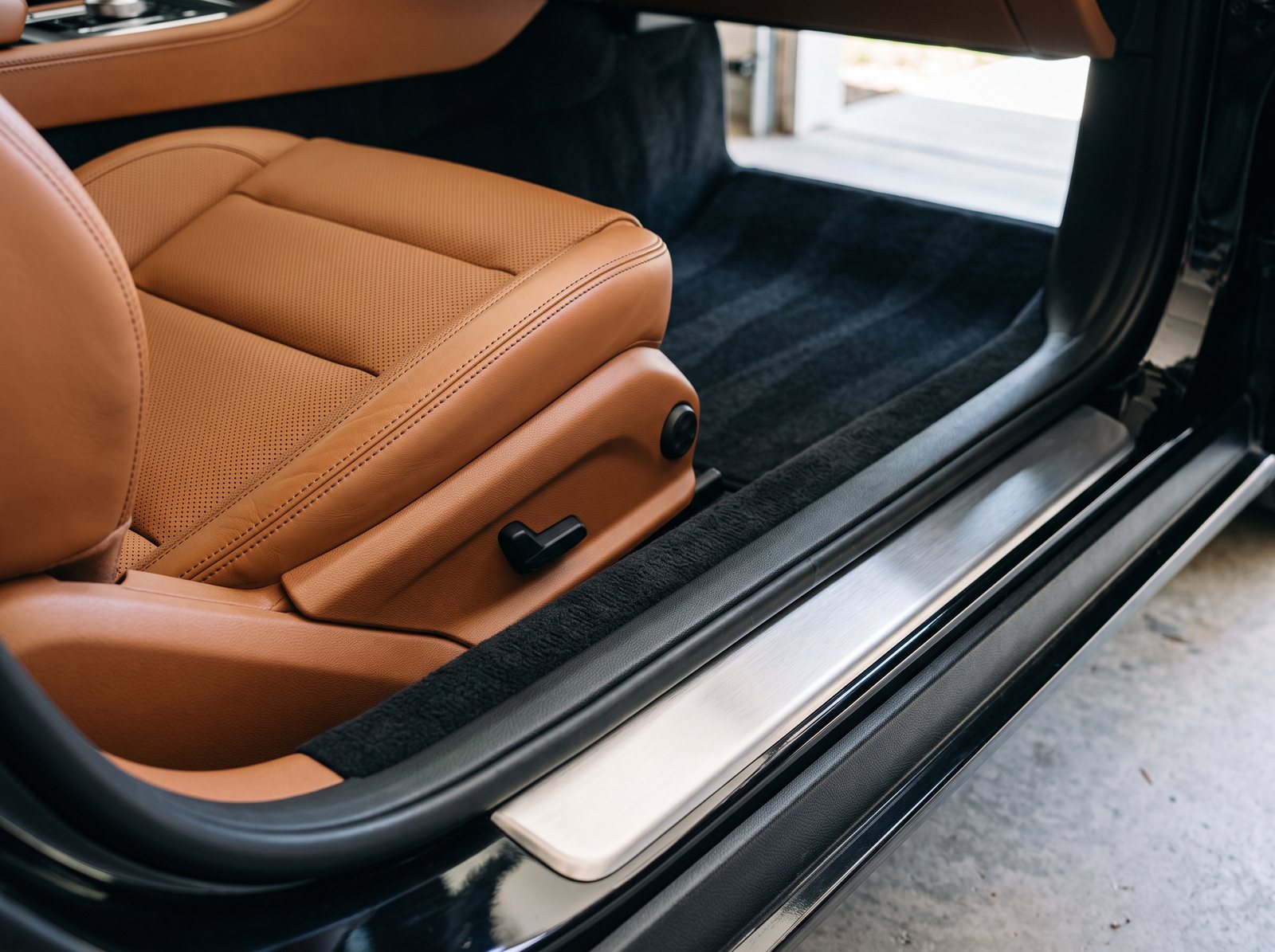 Leather driver seat and door sill after an interior detail